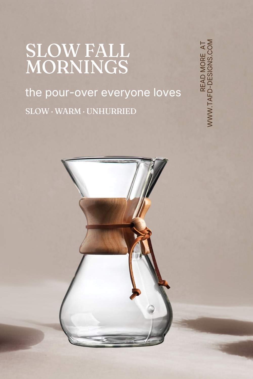 A glass Chemex pour-over coffee maker on a wooden counter in soft morning light